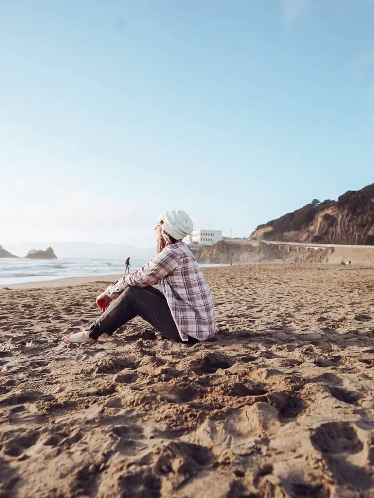 Sitting on the beach at sunset in San Francisco, CA.