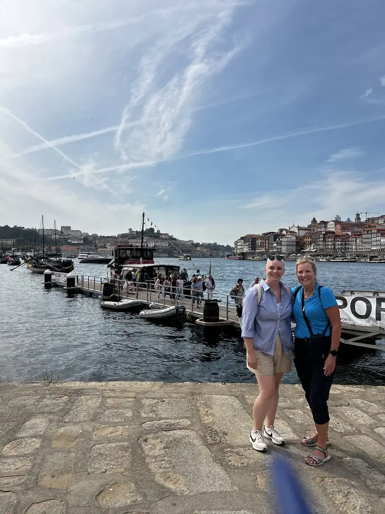 Wearing a button down and trouser shorts on the river in Porto, Portugal.