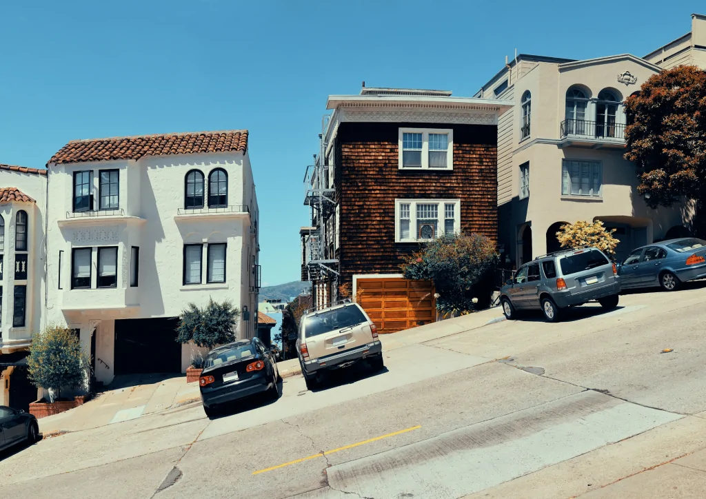 Steep hill in San Francisco with cars parked on it. 