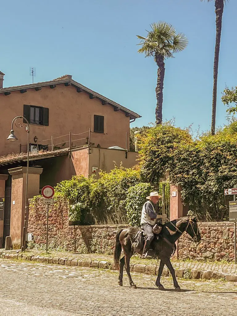 Man riding a horse on the Appian Way in Rome, Italy.