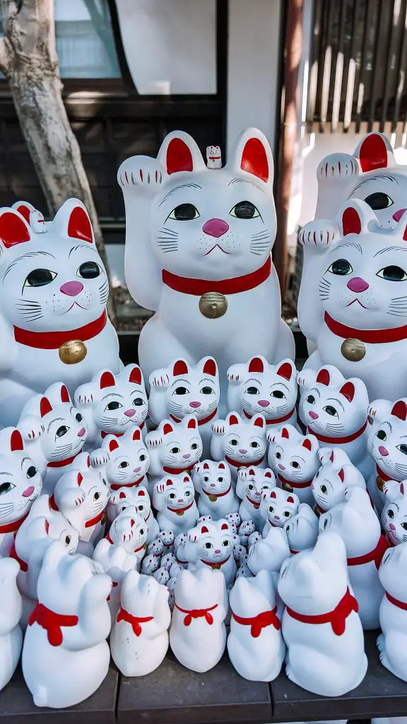 Maneki-neko statues at Gotokuji Shrine in Tokyo, Japan.