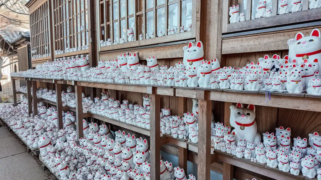 Maneki-neko statues at Gotokuji Shrine in Tokyo, Japan.