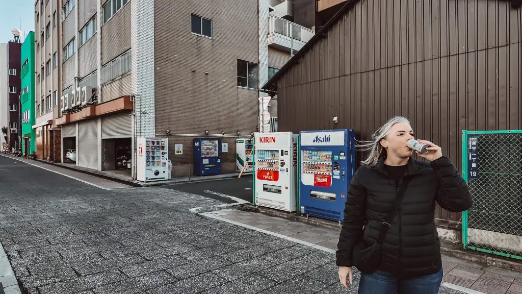 Drinking tea from a vending machine in Tokyo, Japan.
