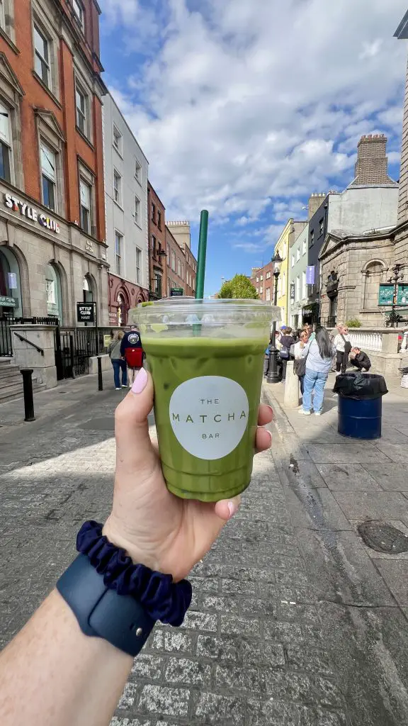 Matcha Latte held up on a Dublin, Ireland street.
