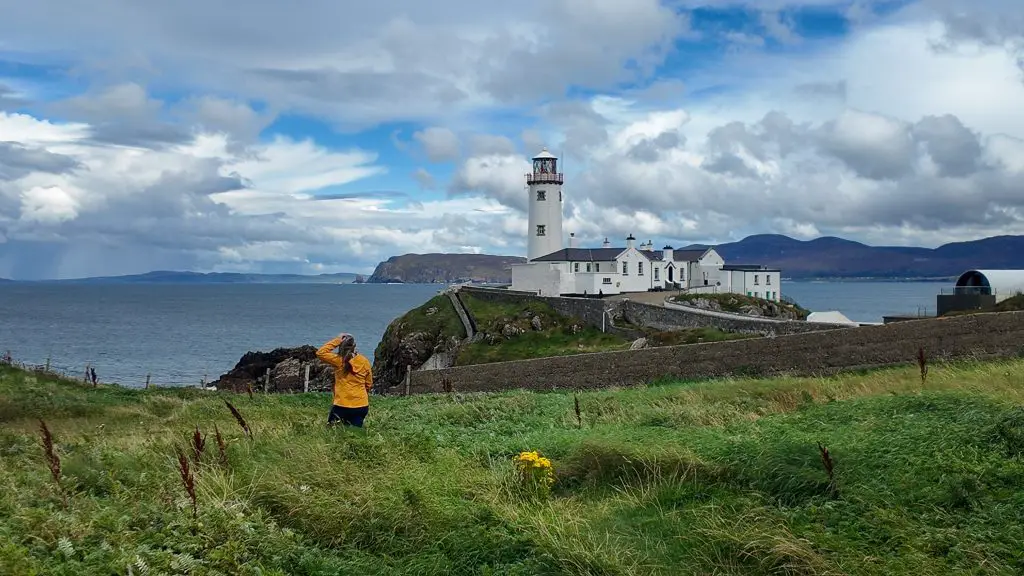 Katie in front of Fanad Head Lighthouse in Donegal, Ireland.