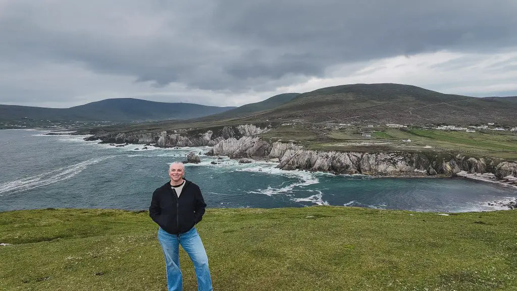 Katie standing on a cliff overlooking the White Cliffs of Ashleam on Achill Island in Ireland.