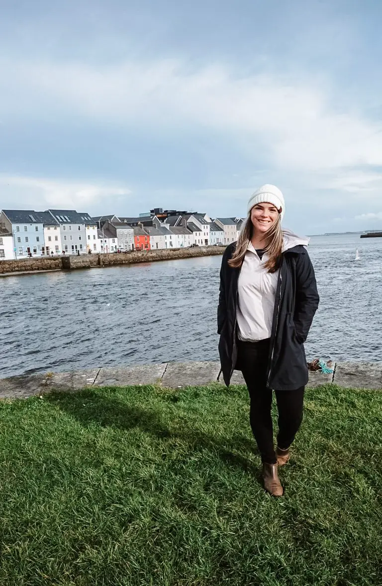 Katie in front of the colorful houses of the Long Walk in Galway, Ireland.