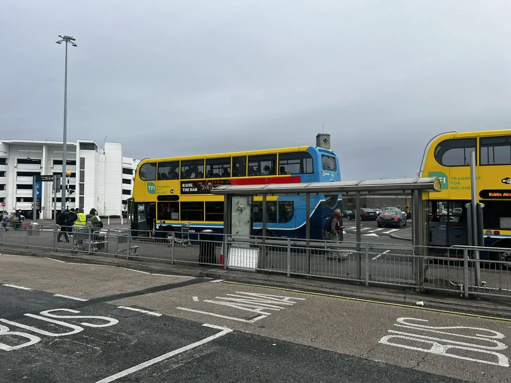 Blue and yellow Dublin buses at the Dublin airport.