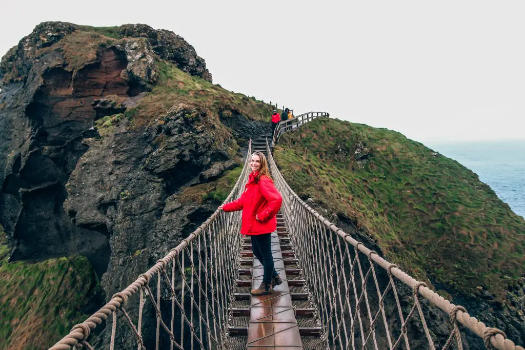 The best jacket for Ireland. Katie wearing a red jacket on the Giants Causeway in Ireland.