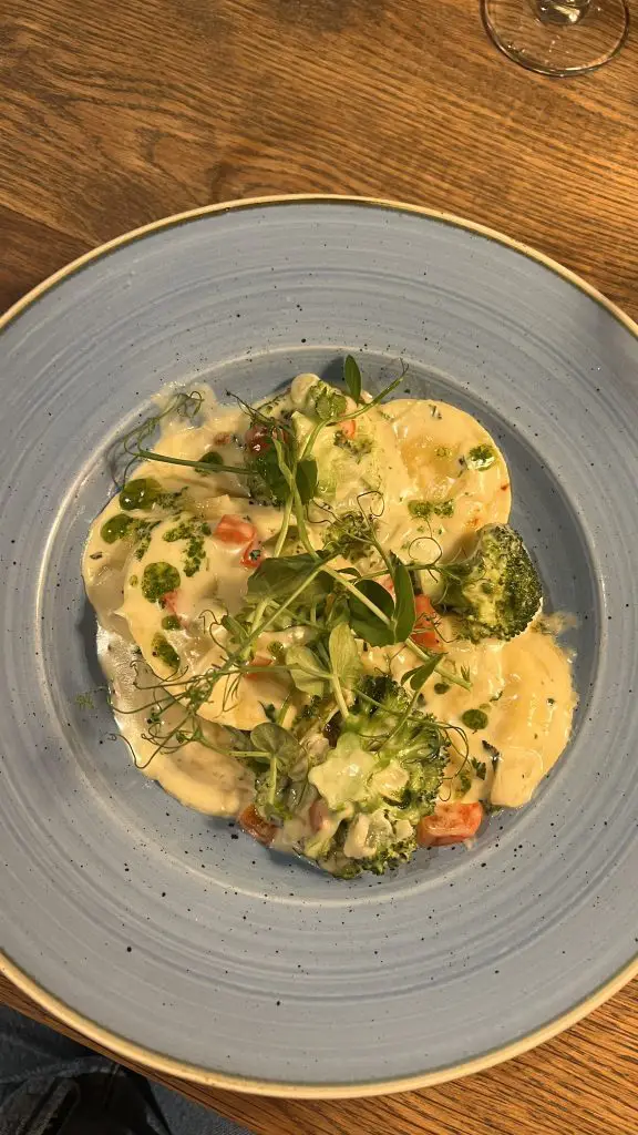 Bowl of seafood pasta on a blue plate at dinner in Clifden, Ireland.