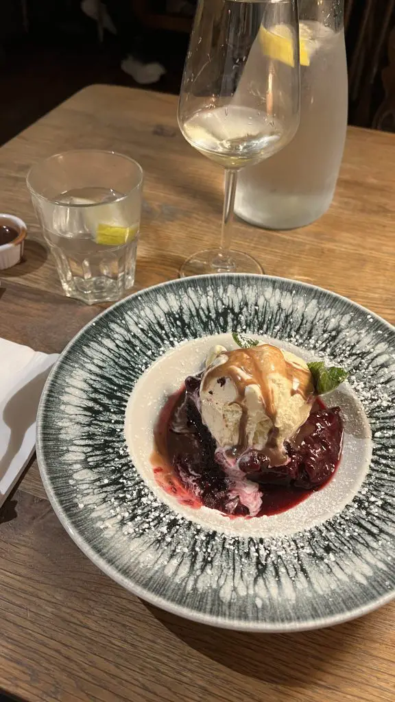 Plate of ice cream and an empty glass of wine in Clifden, Ireland.