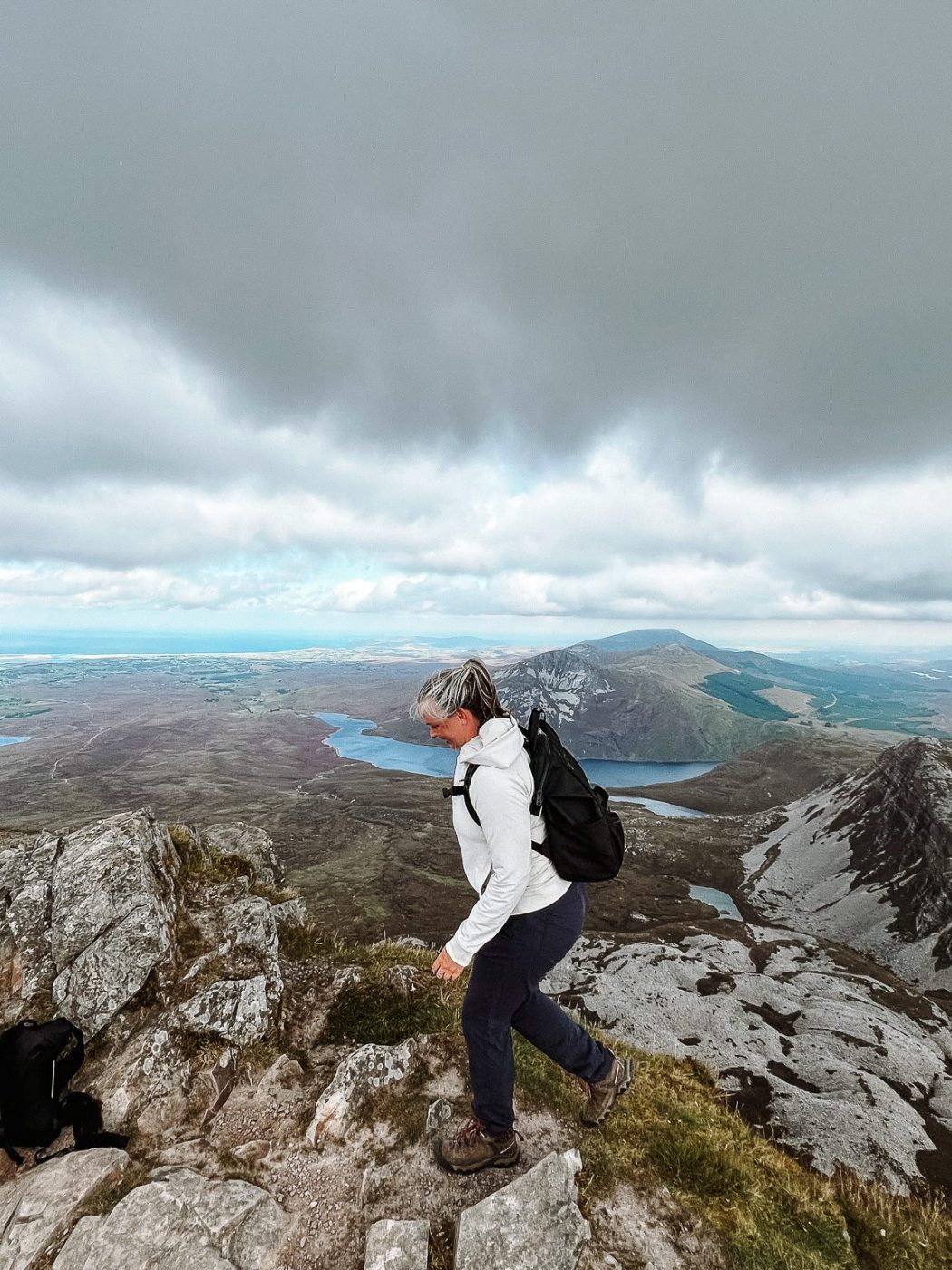 Katie hiking in Donegal, Ireland on a cloudy day.