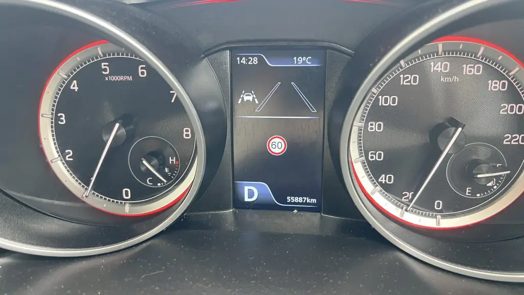 Car dashboard showing fuel tank and mileage.