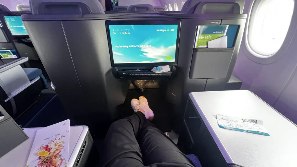 Legs stretched out in a business class seat on Aer Lingus.