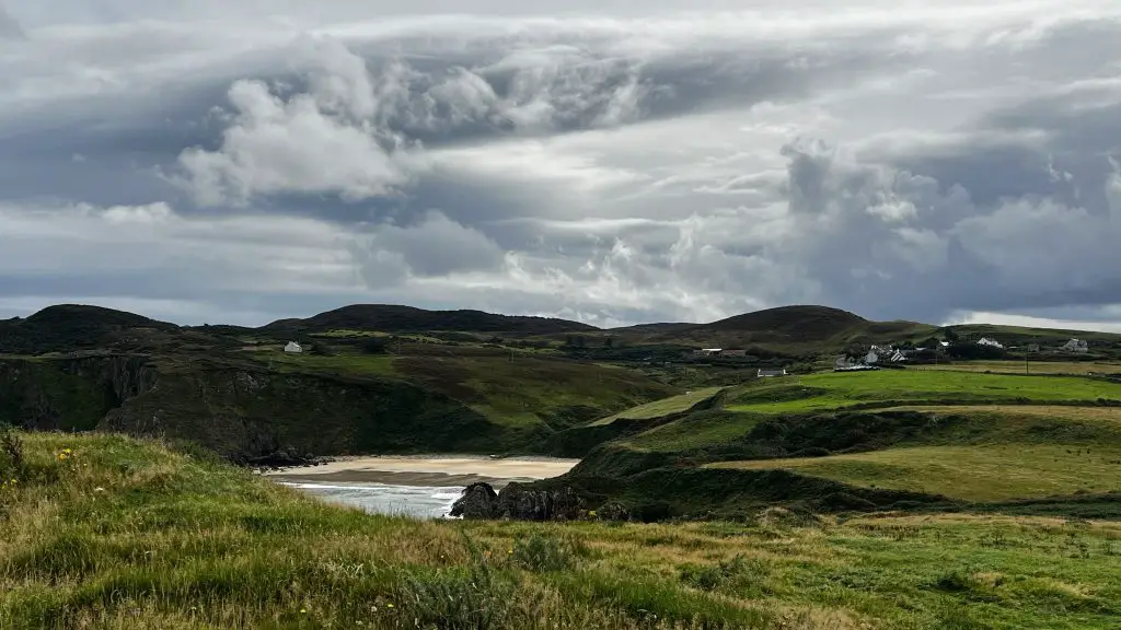 Lush green landscape in Donegal Ireland with a stormy sky.