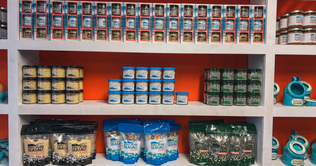 Shelved filled with jars and bags of sea salt varieties.
