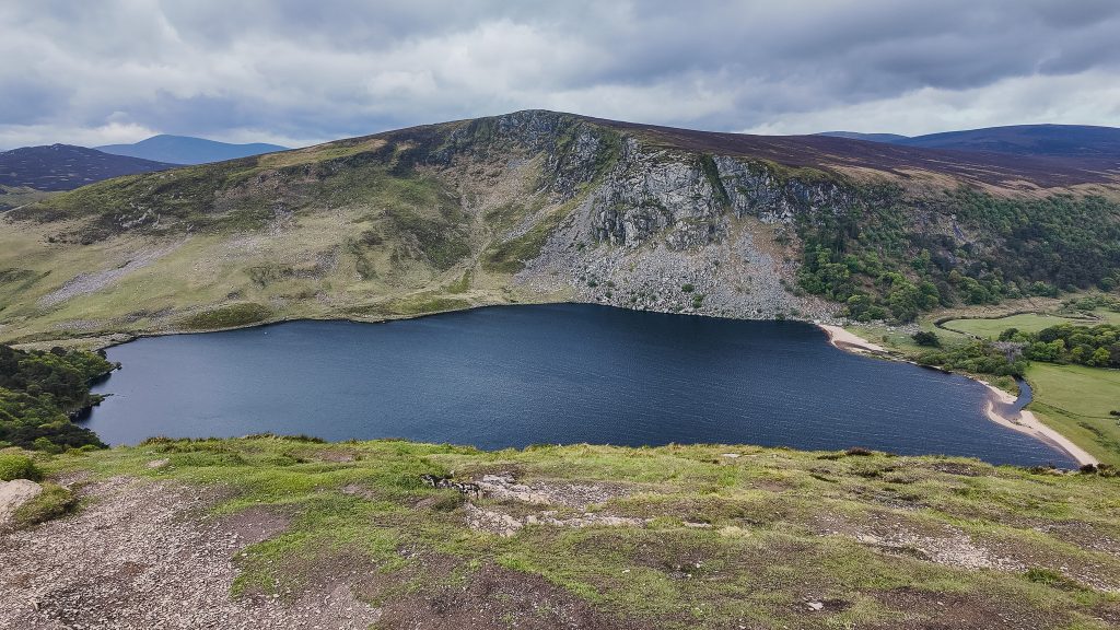 Deep blue lake called Lough Tay surrounded by mountains in Wicklow Ireland.
