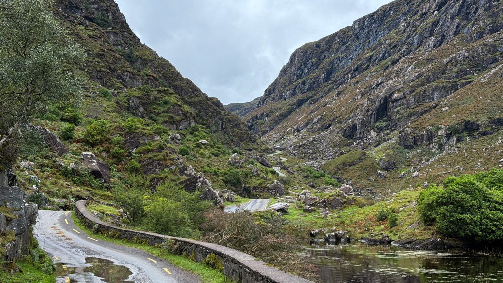 Windy road leads to a mountain pass in Ireland.