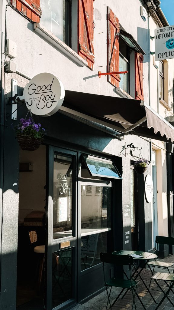 Exterior of a gray coffee shop called Good Boy coffee on a sunny morning in Killarney.